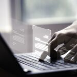 hand using laptop computer with virtual screen document online approve paperless quality assurance erp management concept
